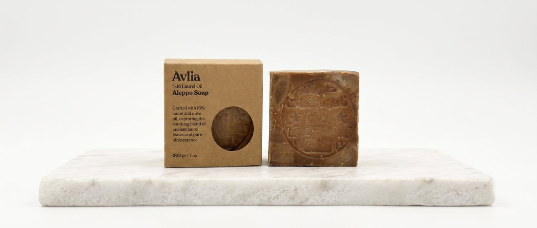 Single Avlia 16% Aleppo soap bar with kraft paper box on white marble — the recommended starting bar for Aleppo soap beginners, simple and approachable