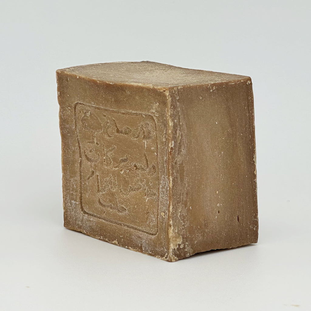 An angled view of the soap bar from the back-right corner, showing the matte, earthy texture and the solid, durable build of the 200g block