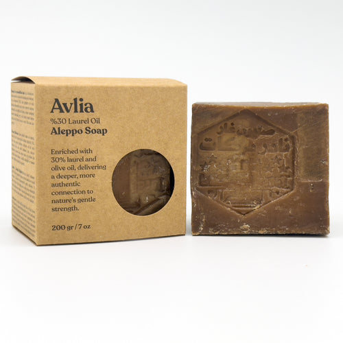 Avlia 30% Laurel Oil Aleppo Soap kraft packaging next to unwrapped bar with traditional stamp