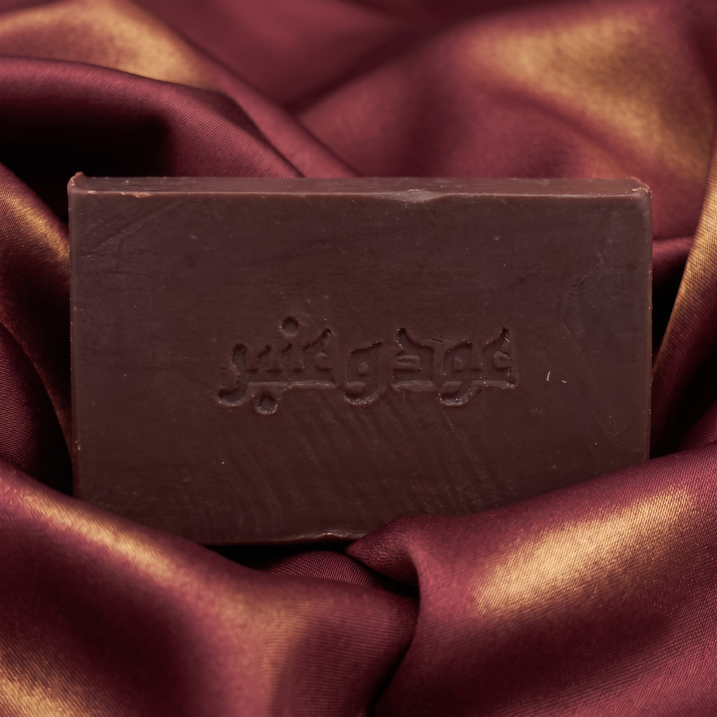 Avlia Oud & Anbar soap resting on deep burgundy silk with golden highlights — luxurious oriental soap perfumed with oud and amber