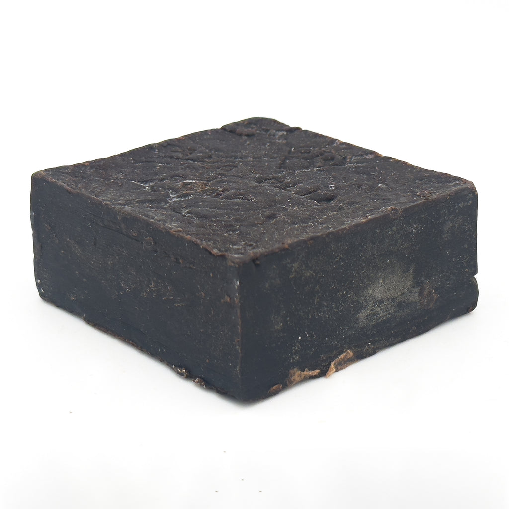 Avlia Pine, Juniper Tar & Sulfur Soap Bar — low-angle view of the bar lying flat, textured top surface of the hand-cut cauldron soap block