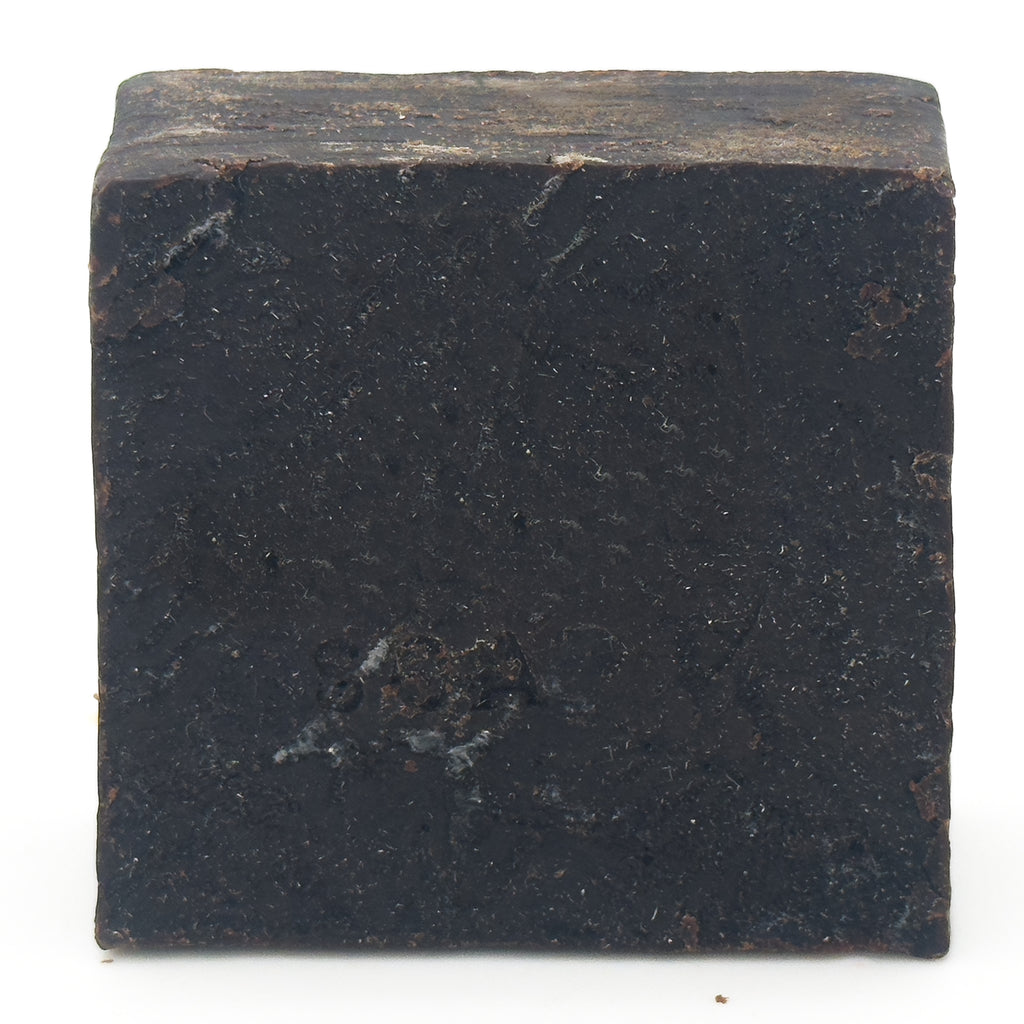 Avlia Pine, Juniper Tar & Sulfur Soap Bar — straight-on view of the matte, flecked cut surface of the near-black handmade soap, 4.8 oz bar