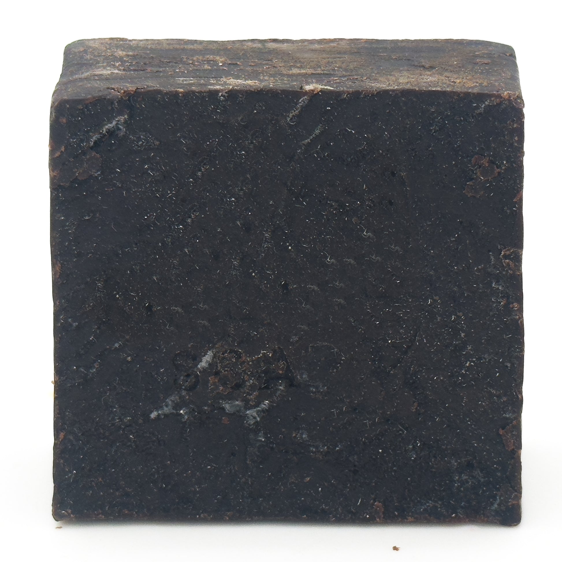 Avlia Pine, Juniper Tar & Sulfur Soap Bar — straight-on view of the matte, flecked cut surface of the near-black handmade soap, 4.8 oz bar