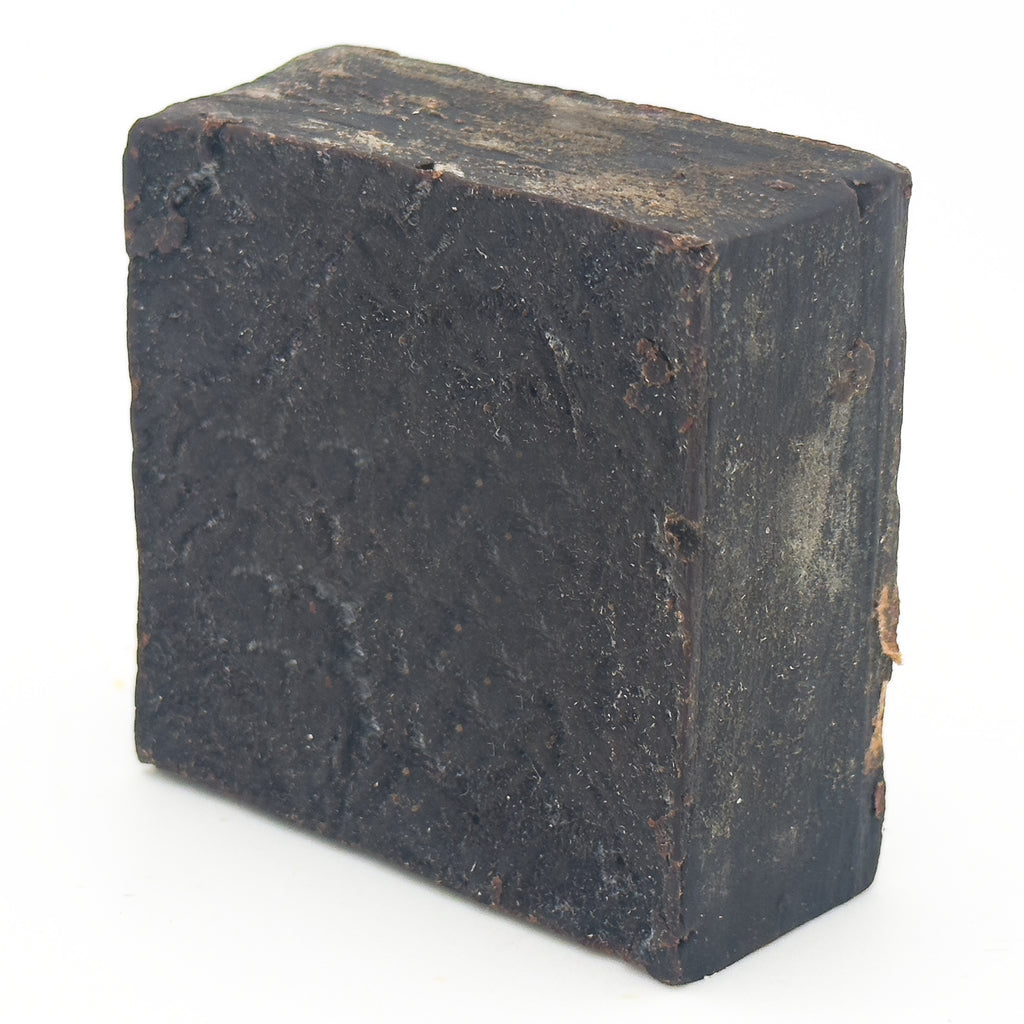 Avlia Pine, Juniper Tar & Sulfur Soap Bar — three-quarter view showing the rustic top surface and knife marks of the cauldron-made natural soap block