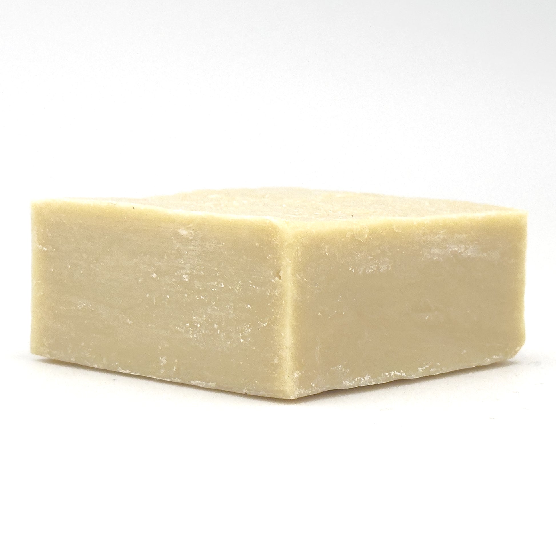 Avlia Turkish Hammam Soap lying flat – low-angle studio shot of the hand-cut natural soap block with lemon and mint on white background