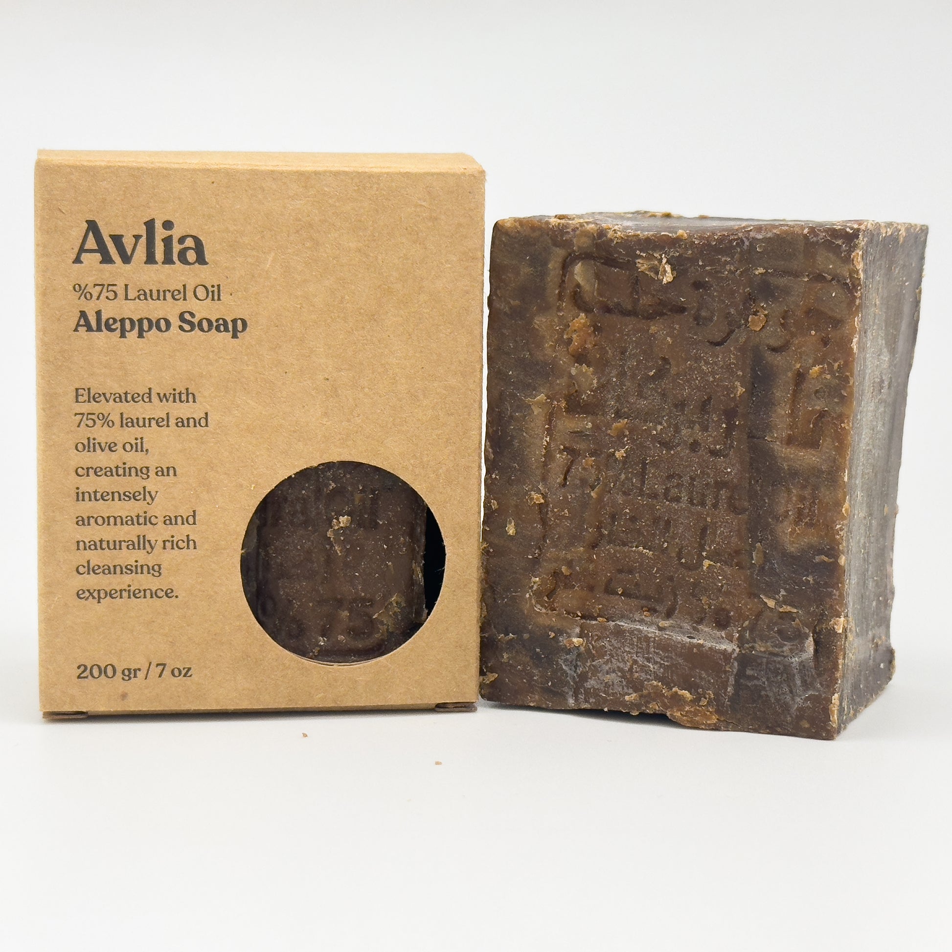 Avlia %75 Laurel Oil Aleppo Soap bar standing next to its kraft paper packaging box