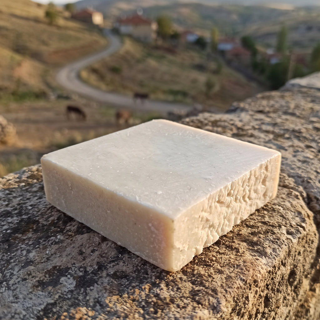 Avlia donkey milk soap on a stone wall, Anatolian village countryside styling.
