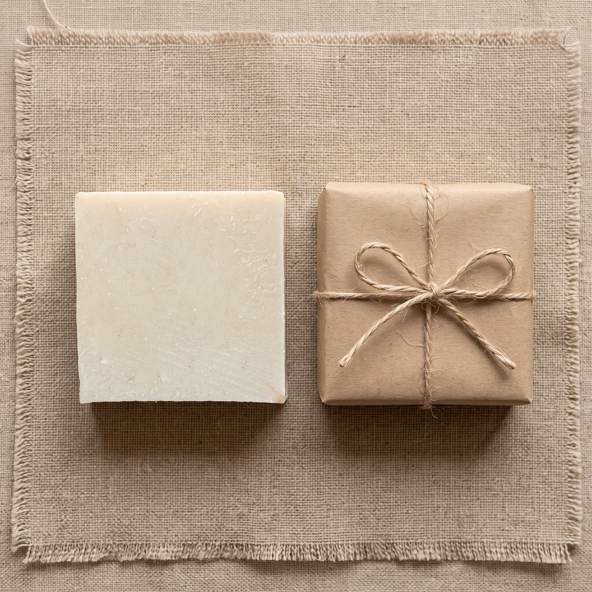 Avlia donkey milk soap with plain kraft wrap and jute twine, minimal packaging flatlay.