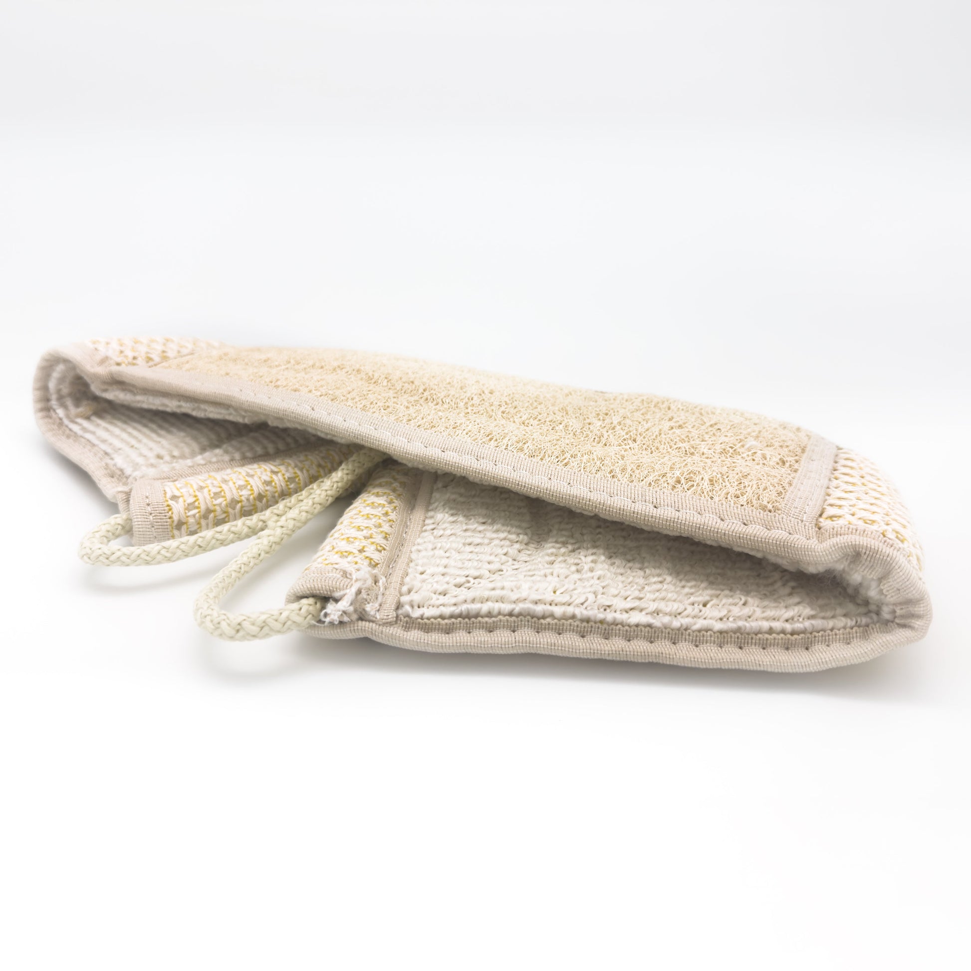 Avlia extra long back strap folded to show both faces at once, the loofah and waffle-knit working face above and the cotton terry reverse below