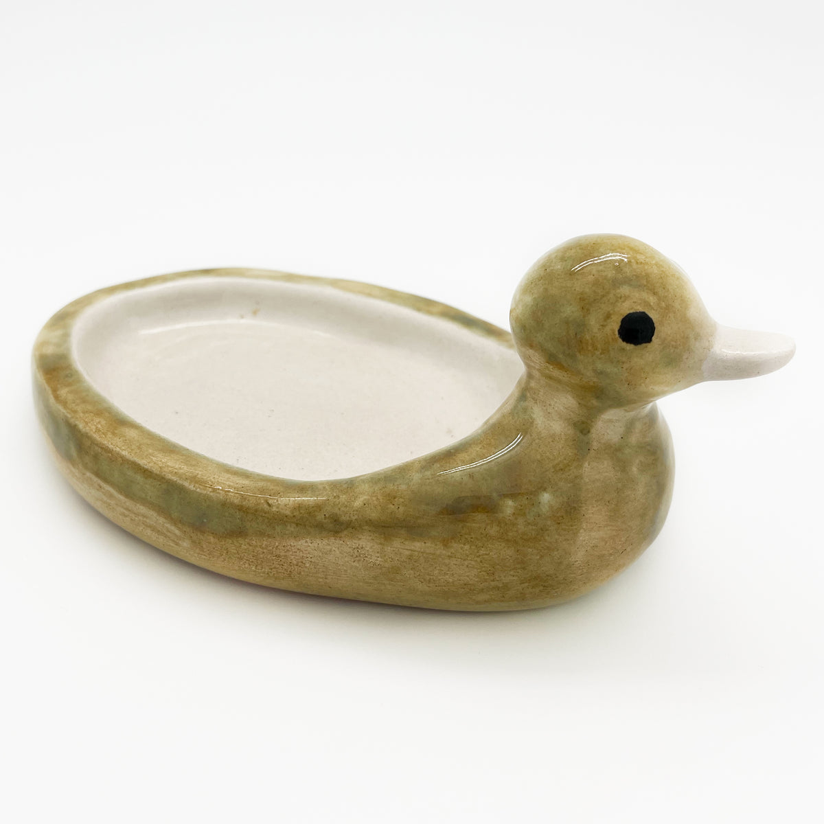 Avlia handmade ceramic duck soap dish seen from behind the tail, the oval bowl running the length of the back towards the head