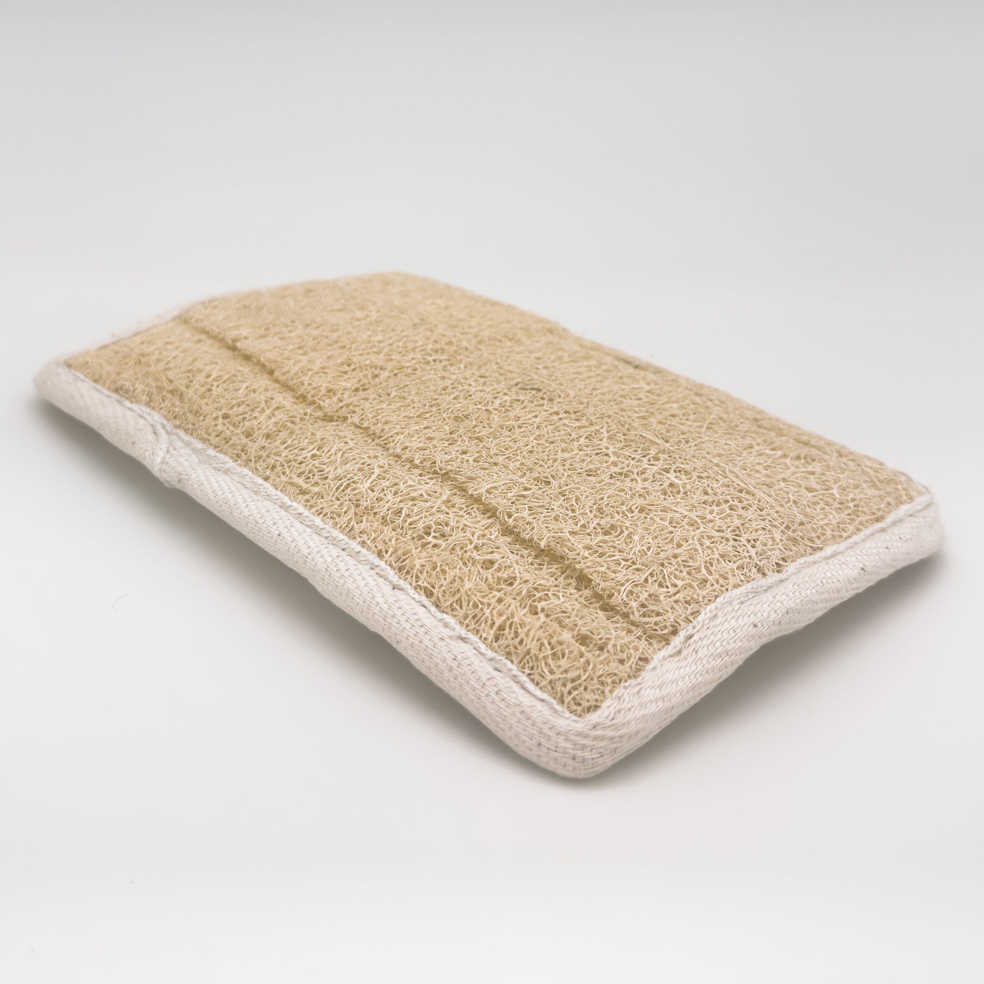 Avlia rectangular loofah bath pad, front loofah face edge to edge with cream cotton bias binding, 23 x 15.5 cm, handmade in Turkiye