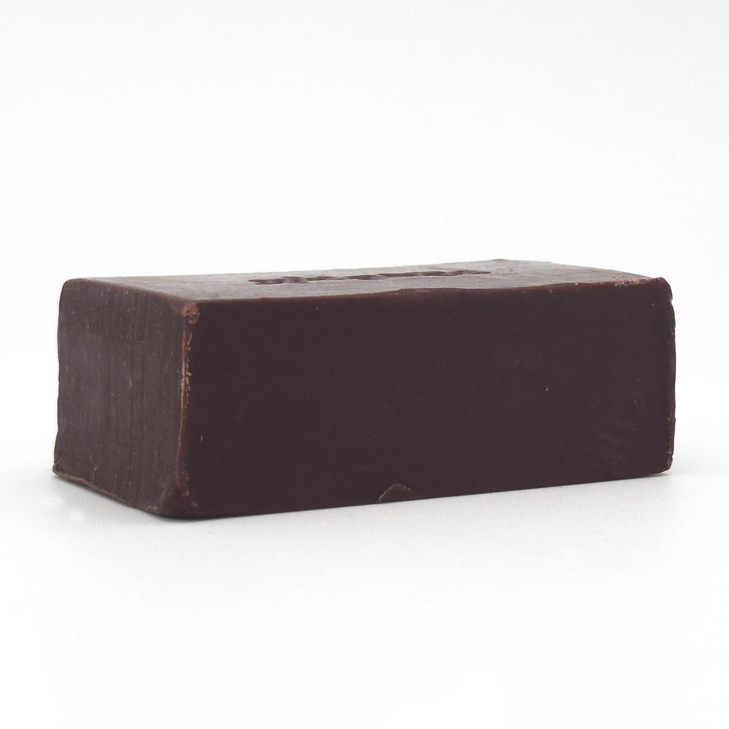 Back view of Avlia Oud & Anbar soap bar showing a smooth, minimal dark brown surface without engraving