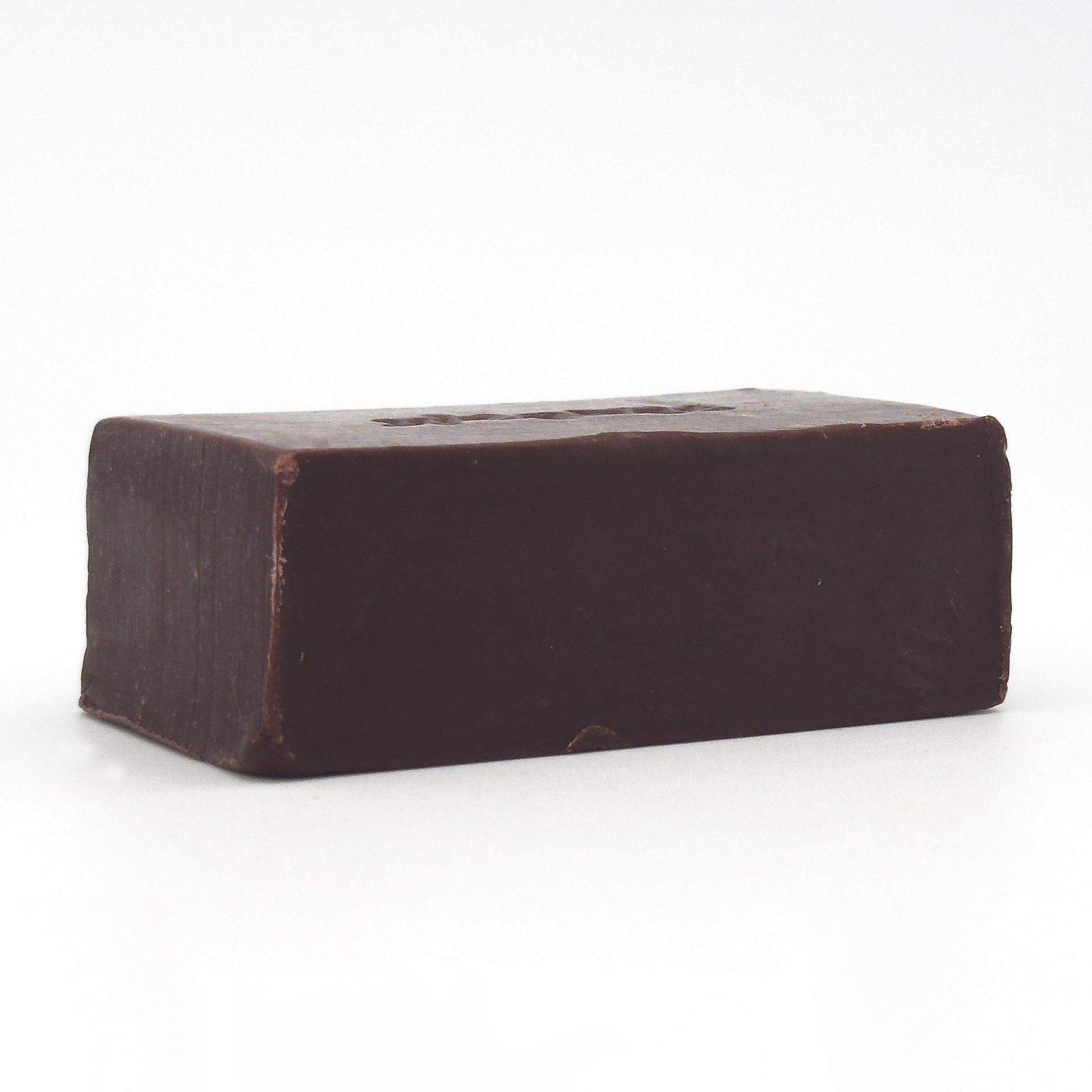 Back view of Avlia Oud & Anbar soap bar showing a smooth, minimal dark brown surface without engraving