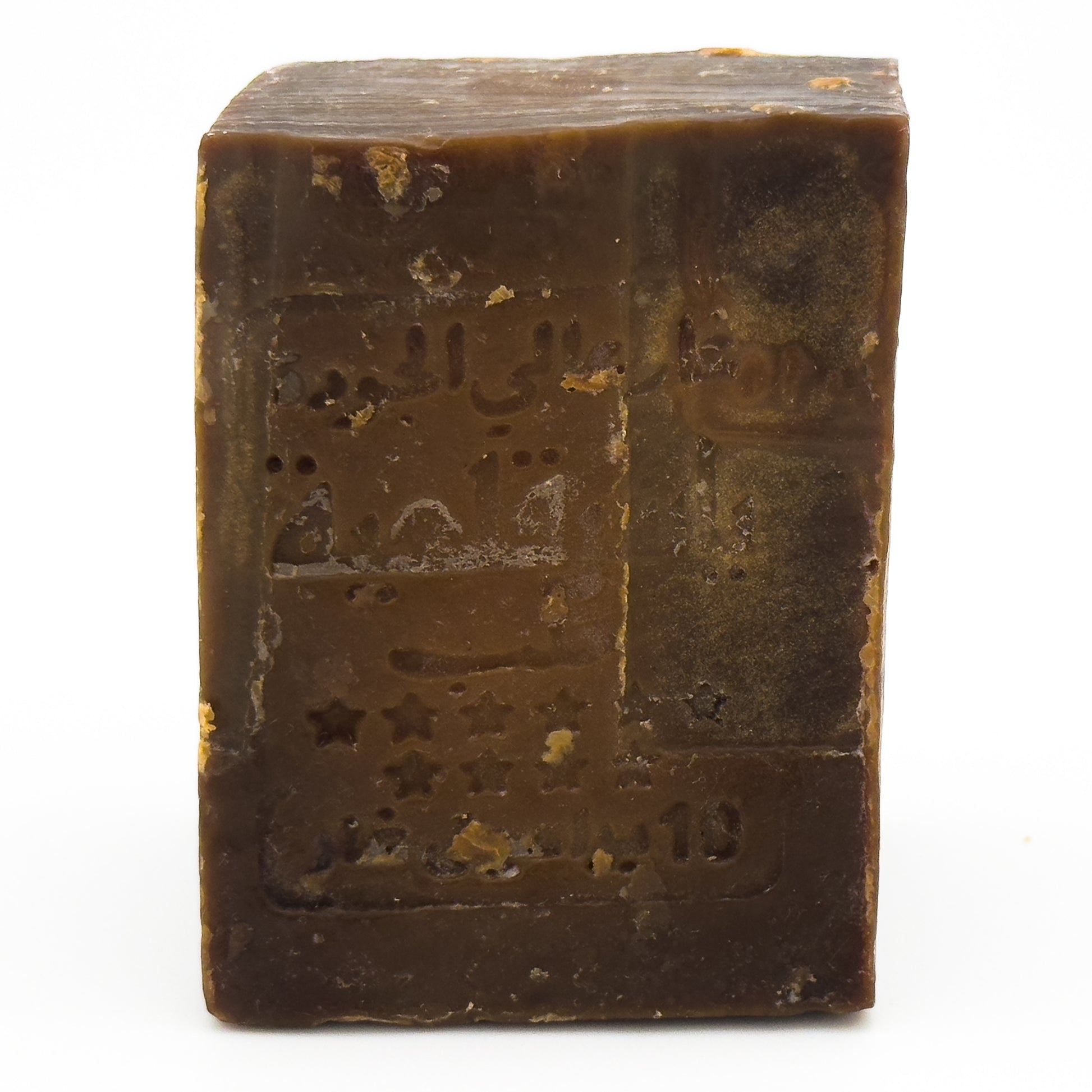 Close-up angled view of the Avlia soap bar, focusing on the stamped logo details and the soap's aged surface Portrait