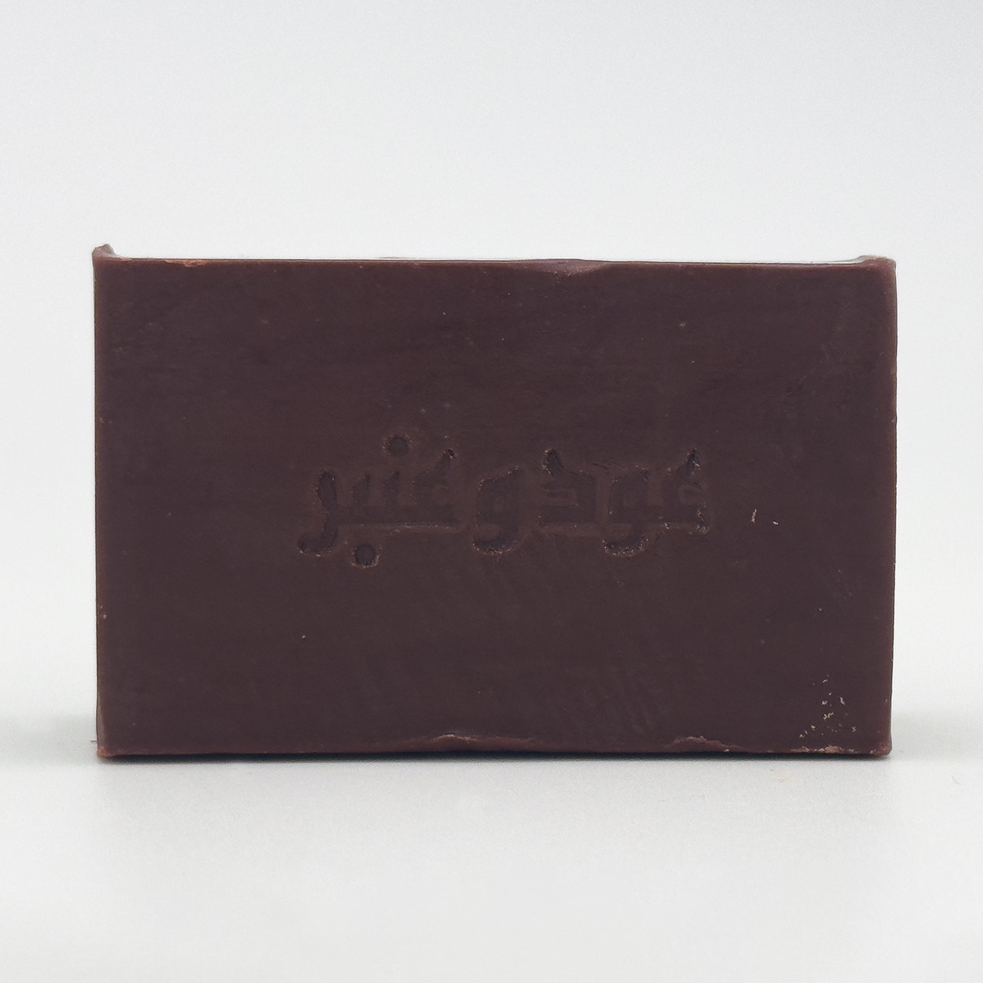 Direct front view of Avlia Oud & Anbar soap bar with clear, centered Arabic text engraving on a white background