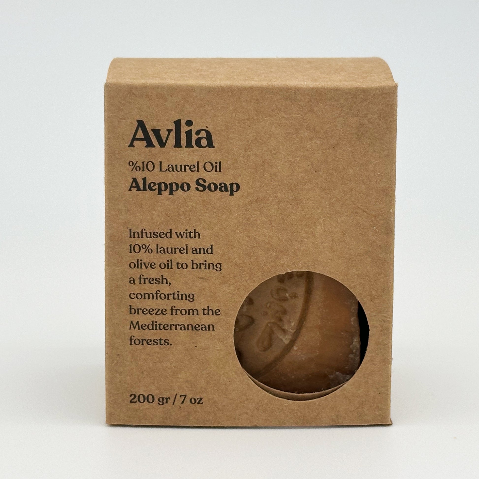 Front view of Avlia 10% Laurel Oil Aleppo Soap packaging in a kraft paper box with a circular cutout window revealing the soap inside