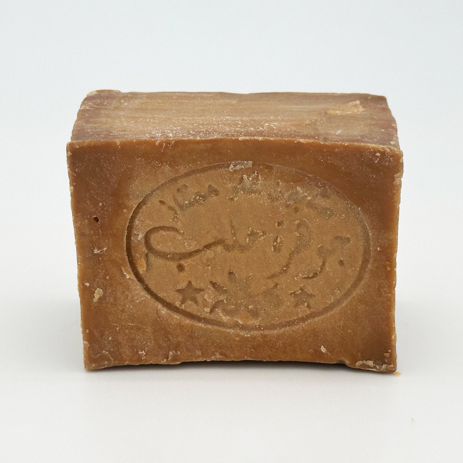 Front view of Avlia Aleppo soap bar highlighting the artisanal stamp and smooth, aged soap texture Portrait