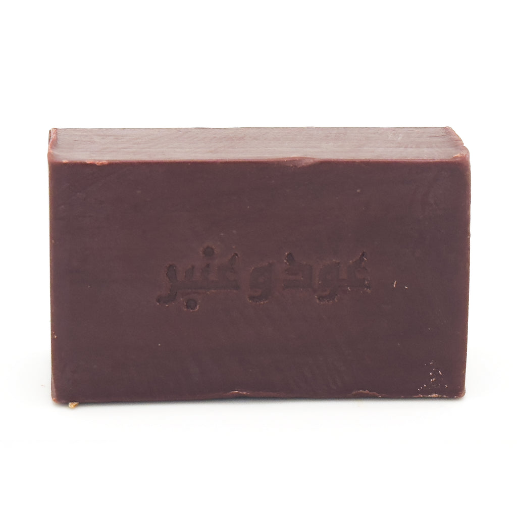 Front view of Avlia Oud & Anbar dark brown soap bar featuring embossed Arabic calligraphy _Oud wa Anbar_