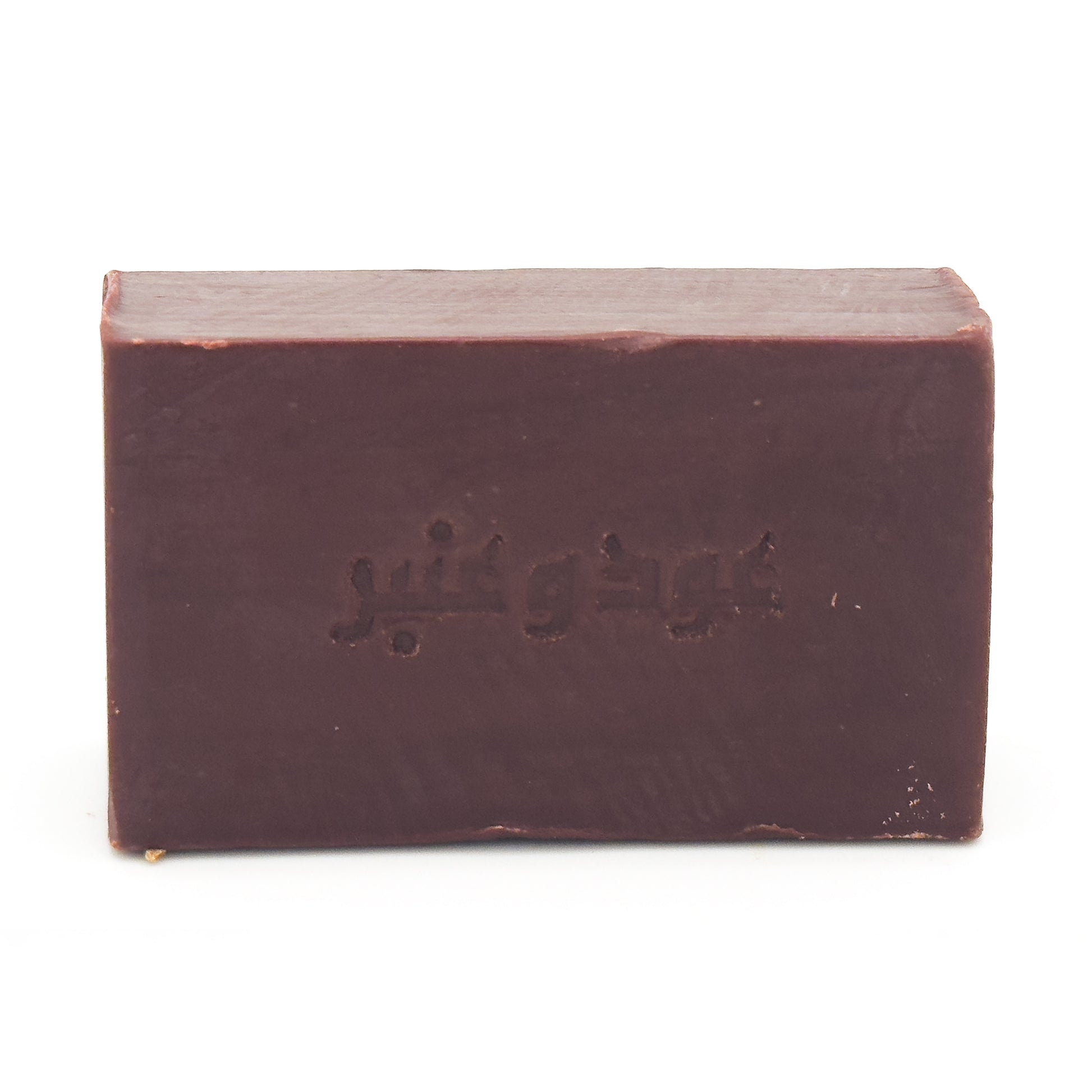 Front view of Avlia Oud & Anbar dark brown soap bar featuring embossed Arabic calligraphy _Oud wa Anbar_