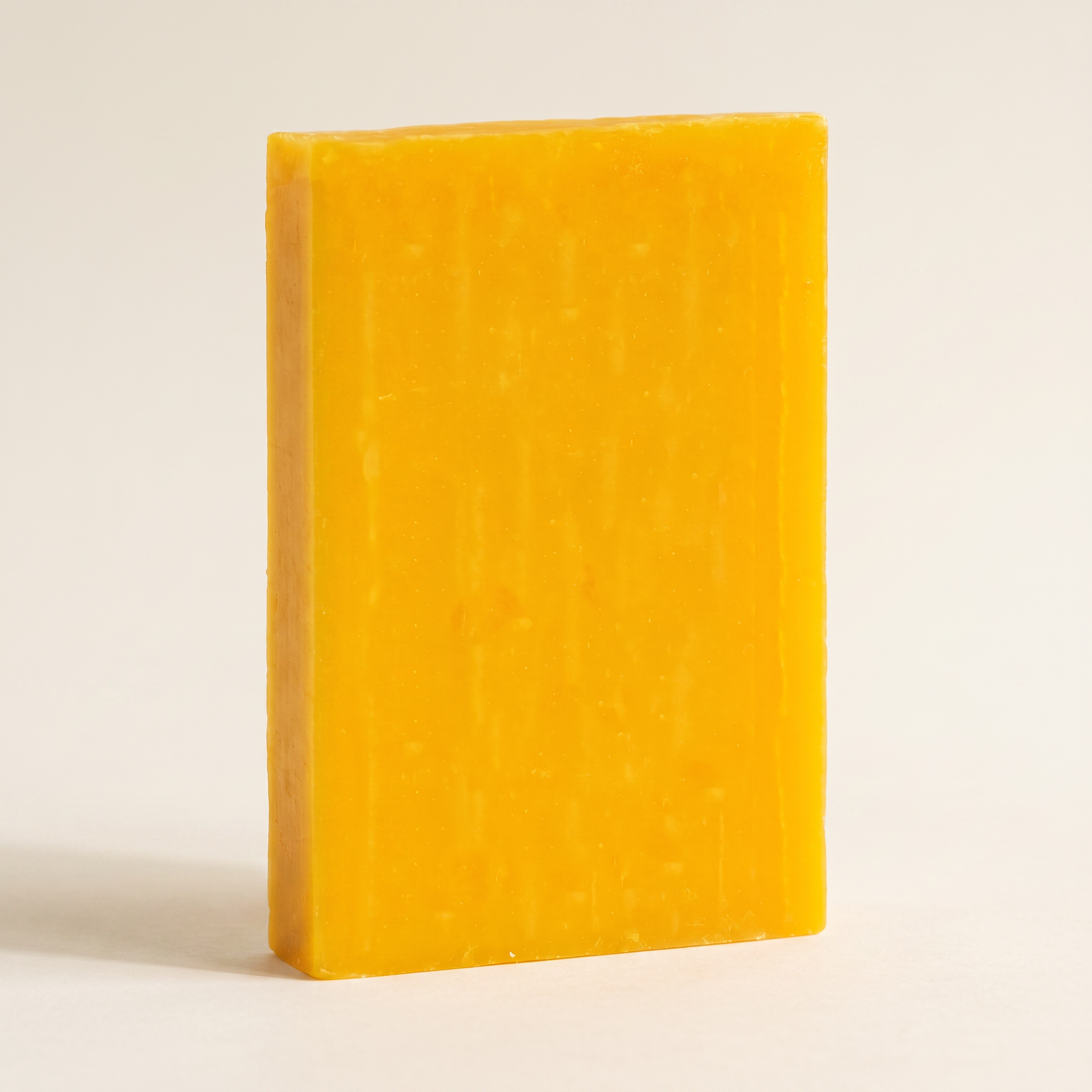 Avlia Glycolic Acid & Orange Soap Bar standing on edge showing hand-cut thickness