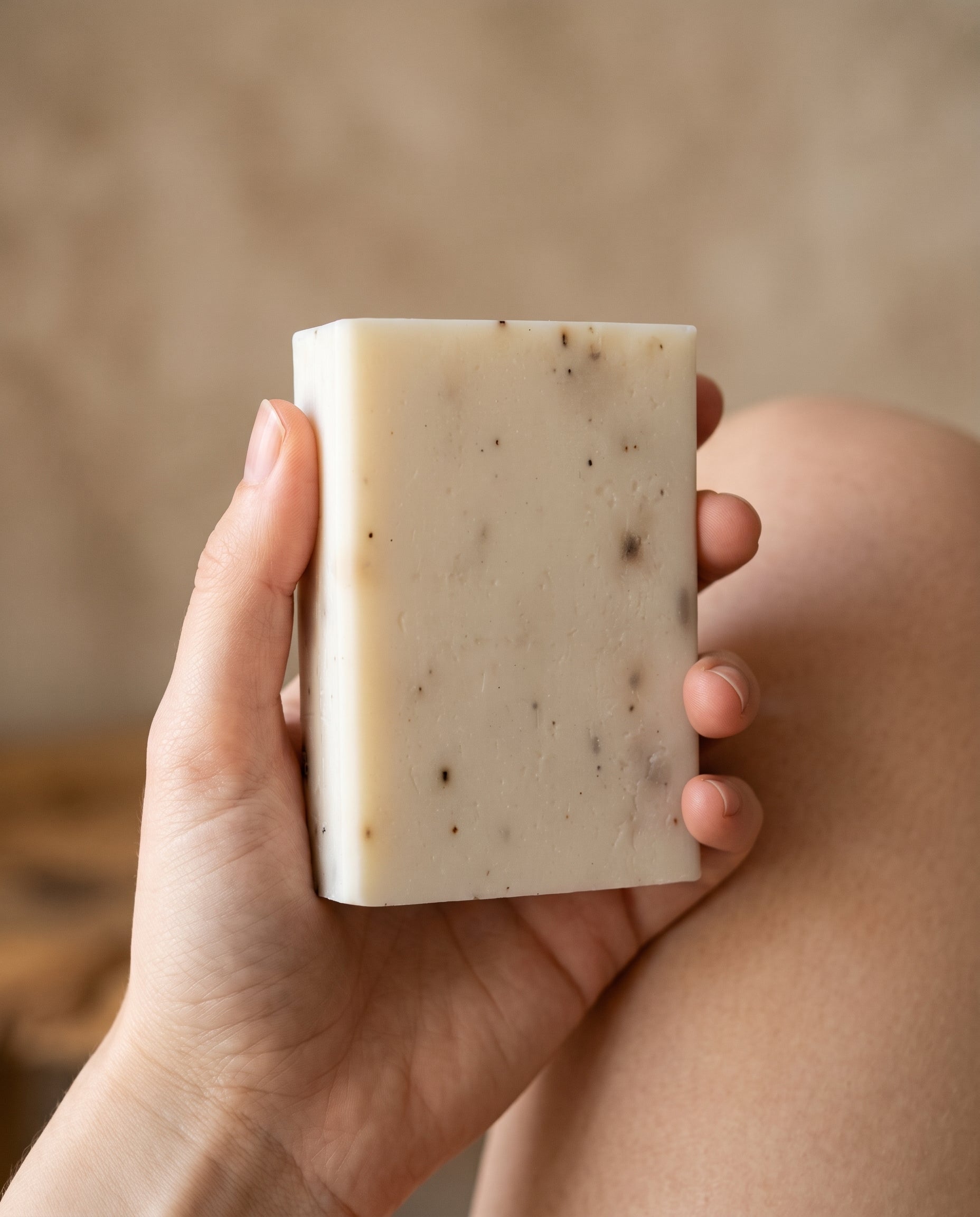 Hand holding Lavender Soap Bar against a soft neutral background, showing the size of the bar