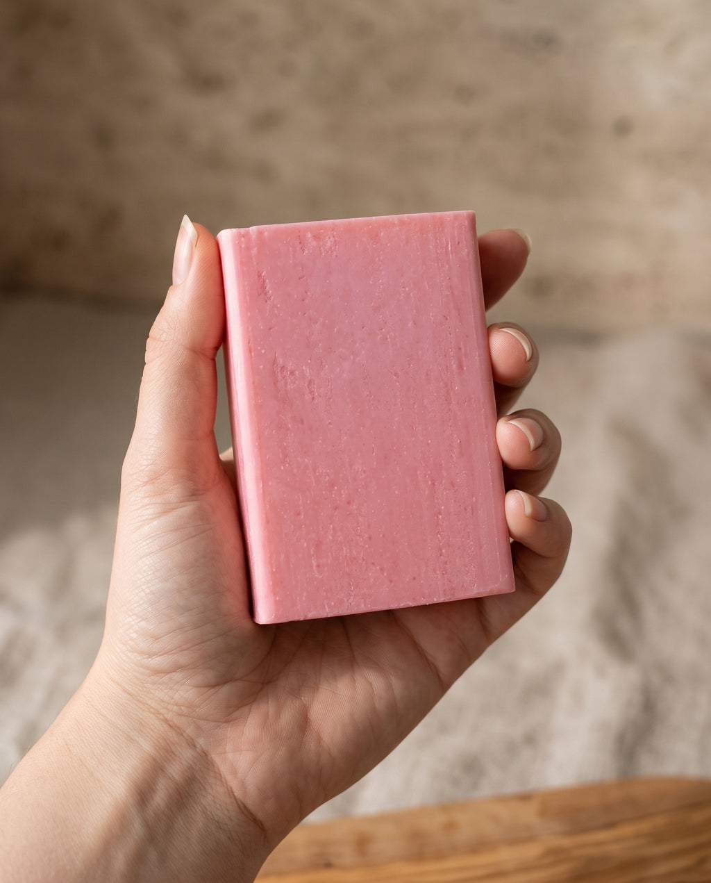 Hand holding Rose Soap Bar against a soft neutral background, showing the size of the bar