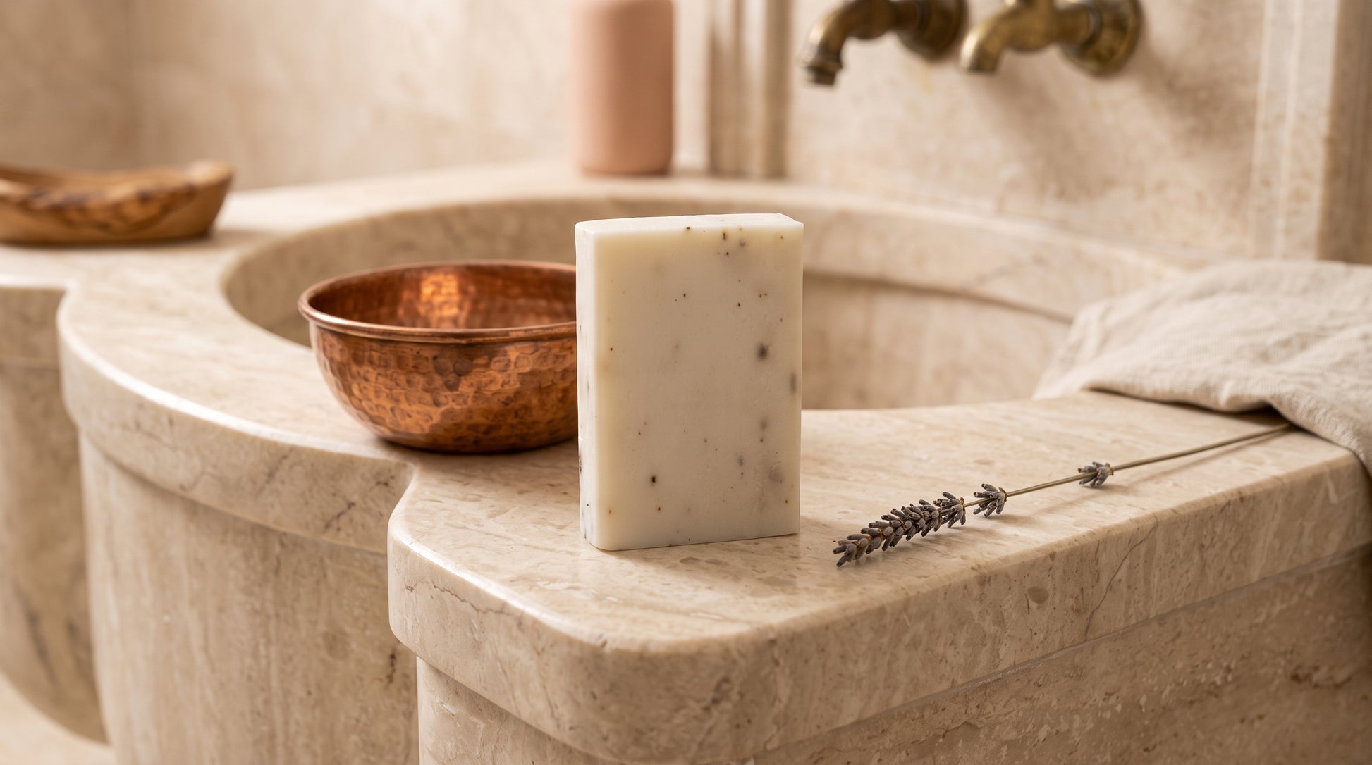 Lavender Soap Bar on the marble edge of a Turkish hammam basin with a hammered copper bowl