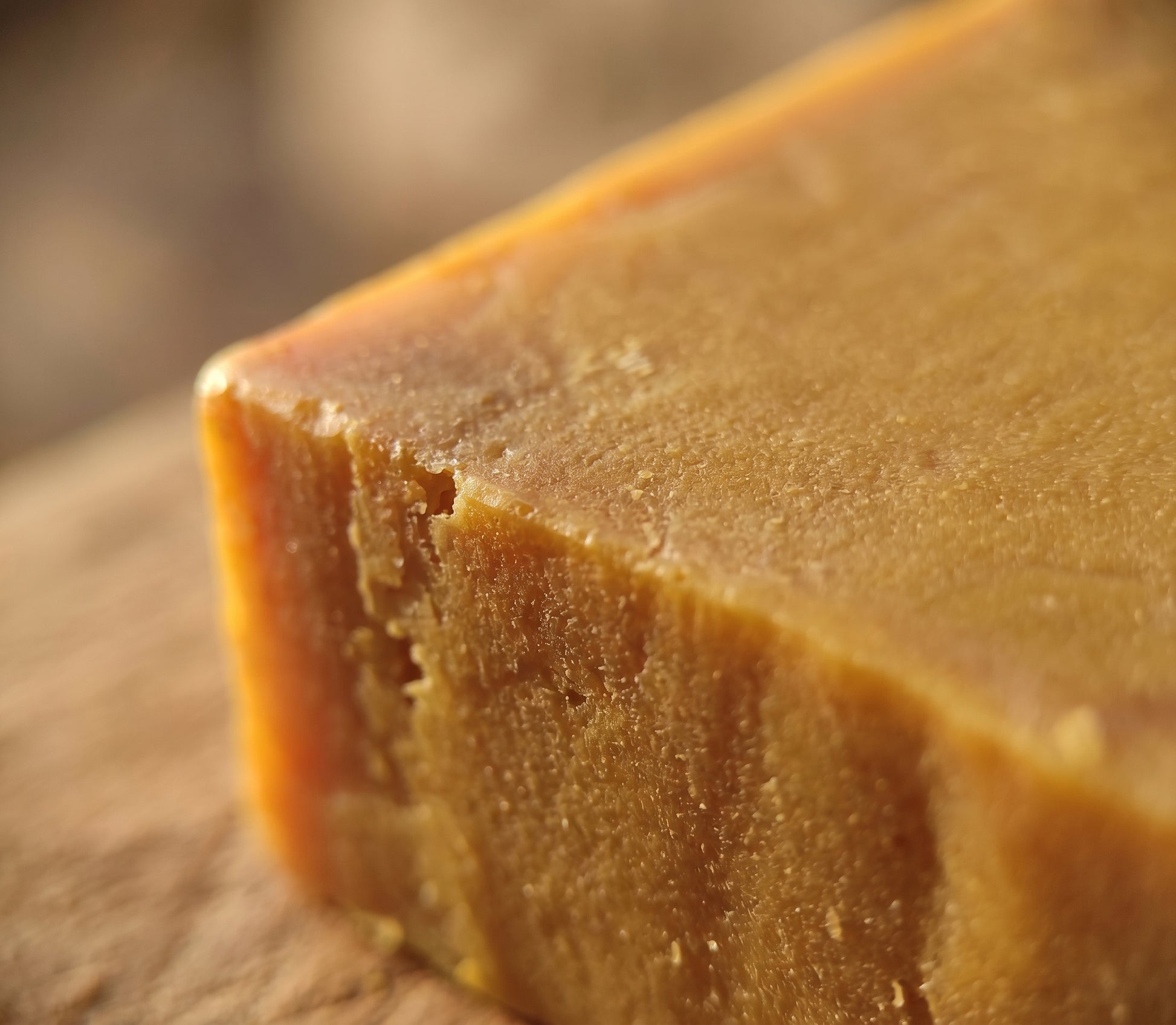 Macro close-up of the Pure Sulfur Soap's rough hand-cut edge and golden-amber texture.