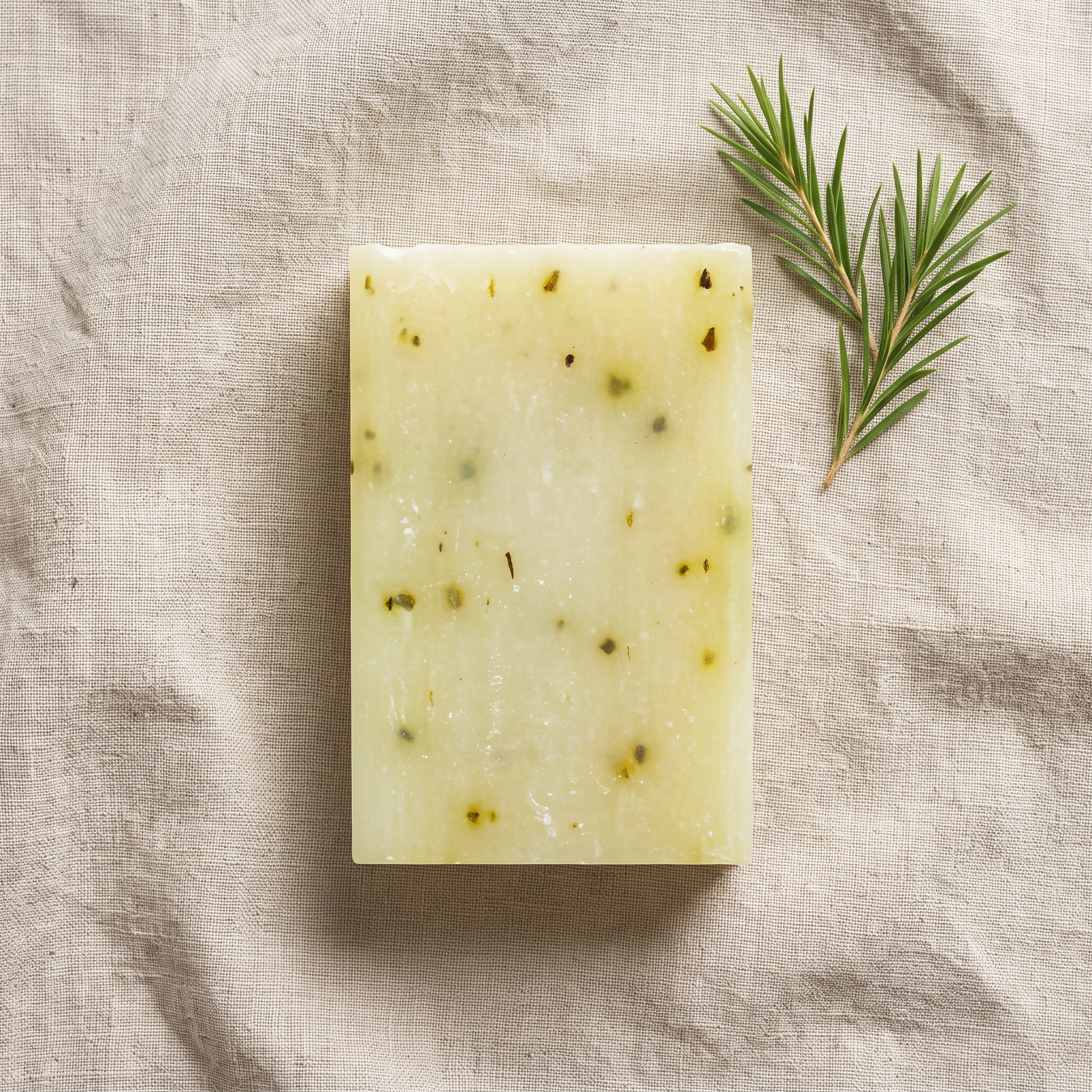 Avlia Tea Tree & Niacinamide Soap Bar flat-lay on natural linen with tea tree sprig