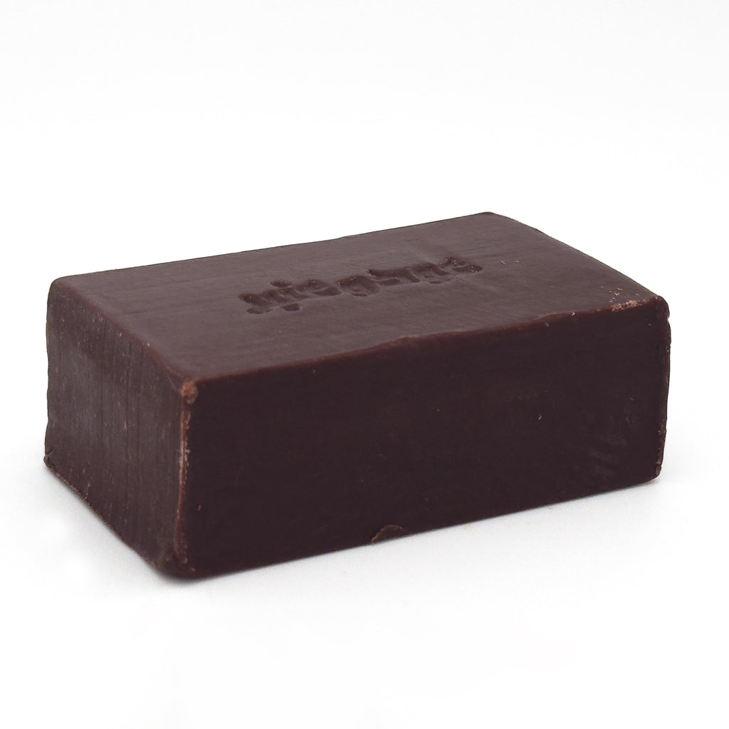 Profile view of Avlia Oud & Anbar soap bar laying flat, displaying the smooth side edge and depth