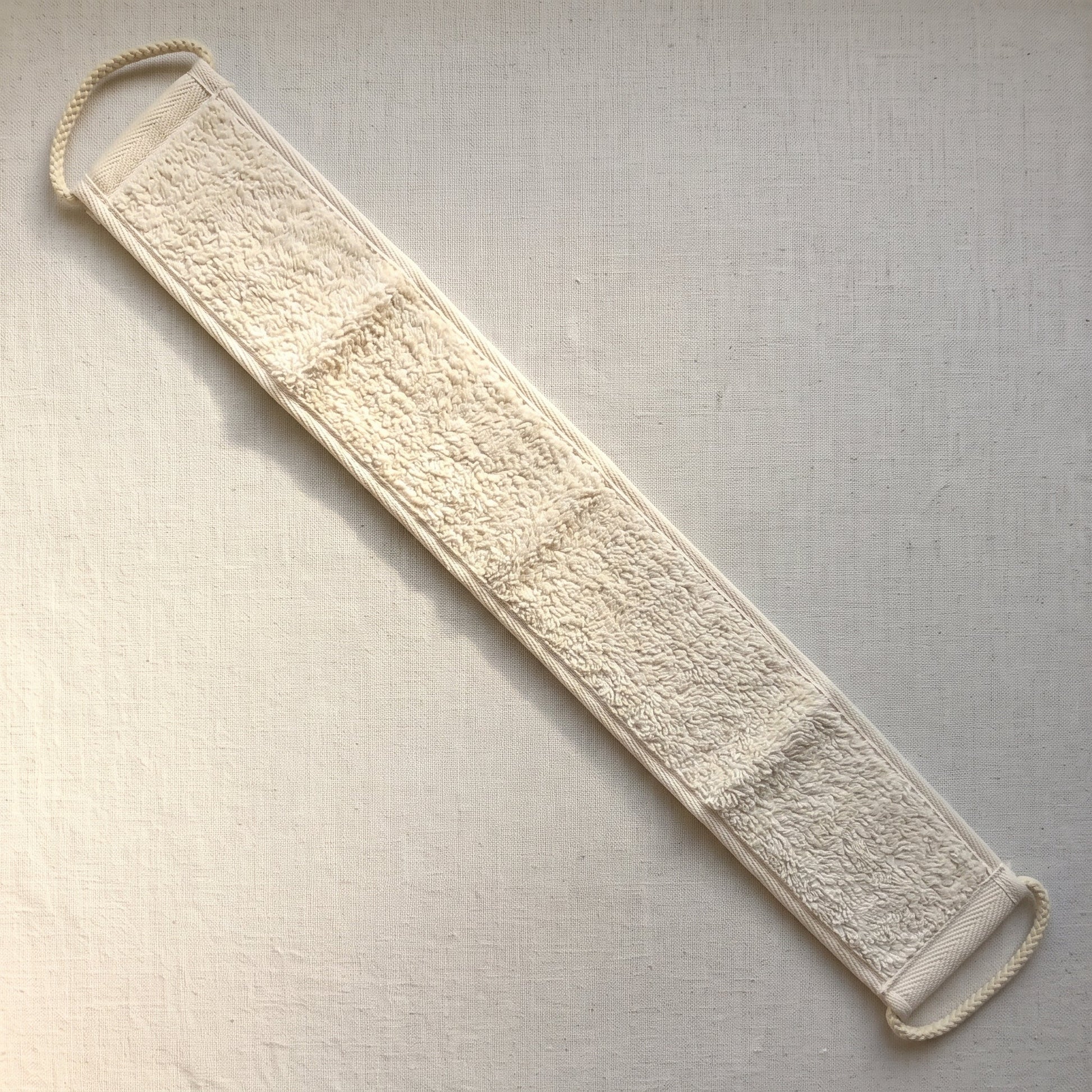 Reverse face of the Avlia back strap, cream cotton terry running the full length with no zones, the softest surface on the strap