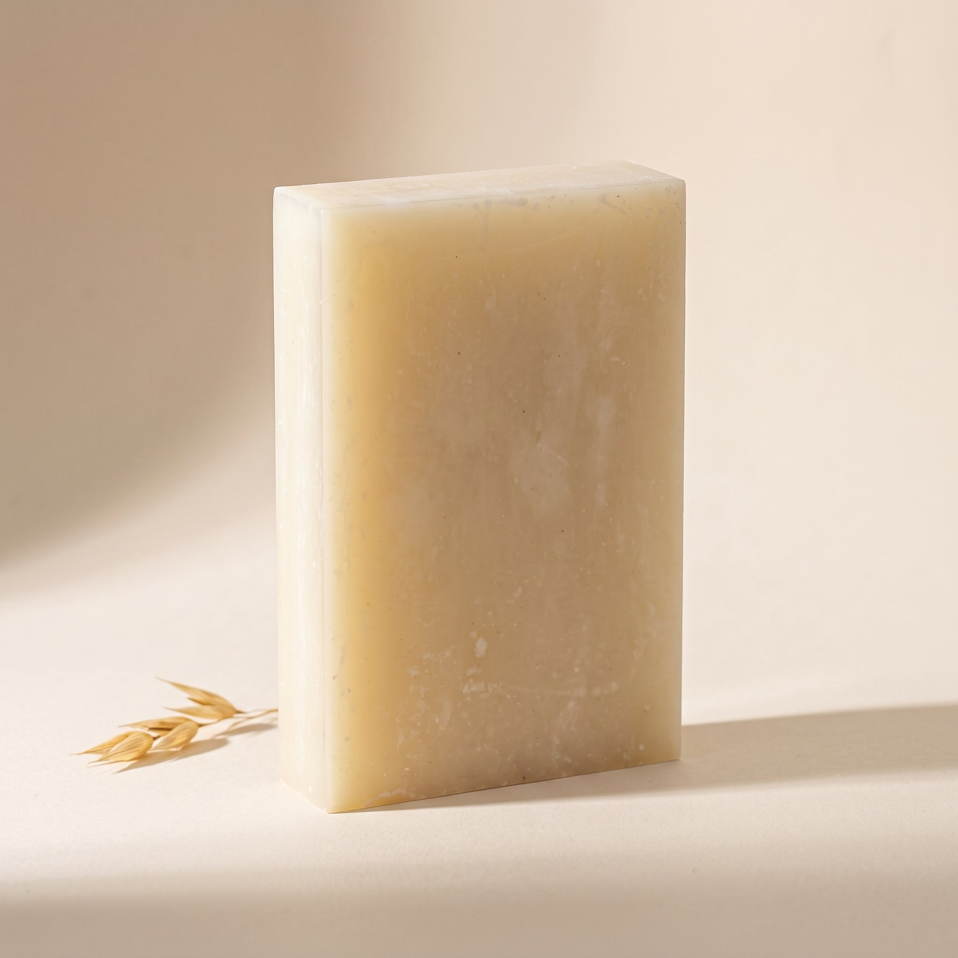 Rice Soap Bar standing on edge against a warm off-white backdrop, showing its hand-cut thickness