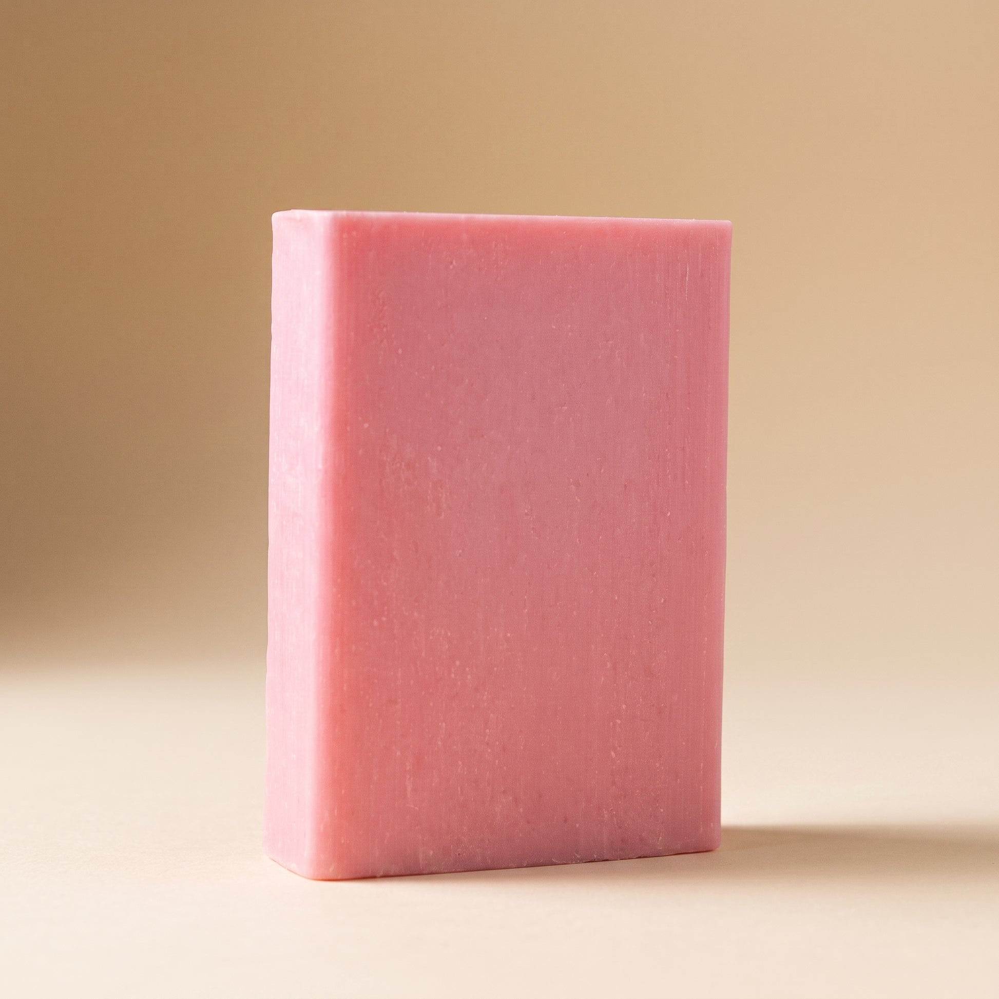 Rose Soap Bar standing on edge against a warm off-white backdrop, showing its hand-cut thickness