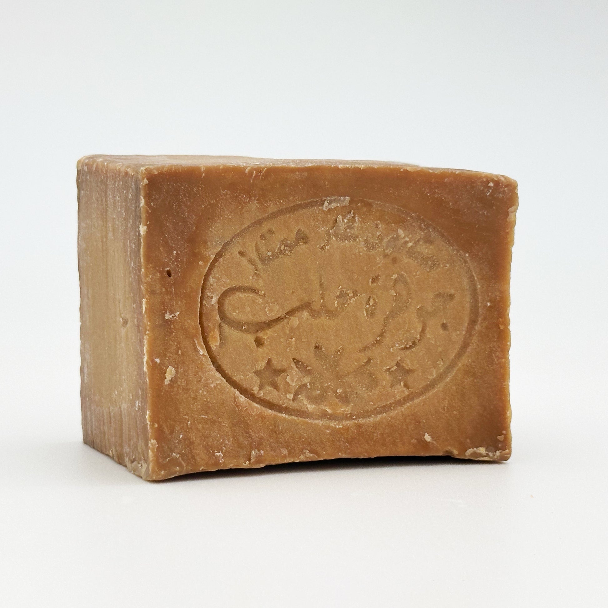 Side angle of Avlia Aleppo soap bar showing thickness and stamped branding details Portrait