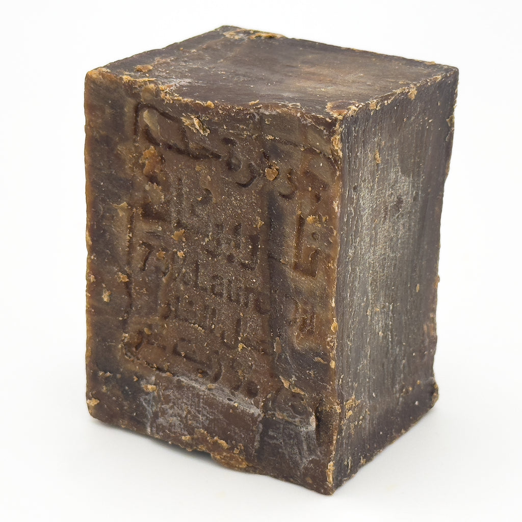 Side angle view of Avlia Aleppo Soap showing the block thickness and natural aging texture