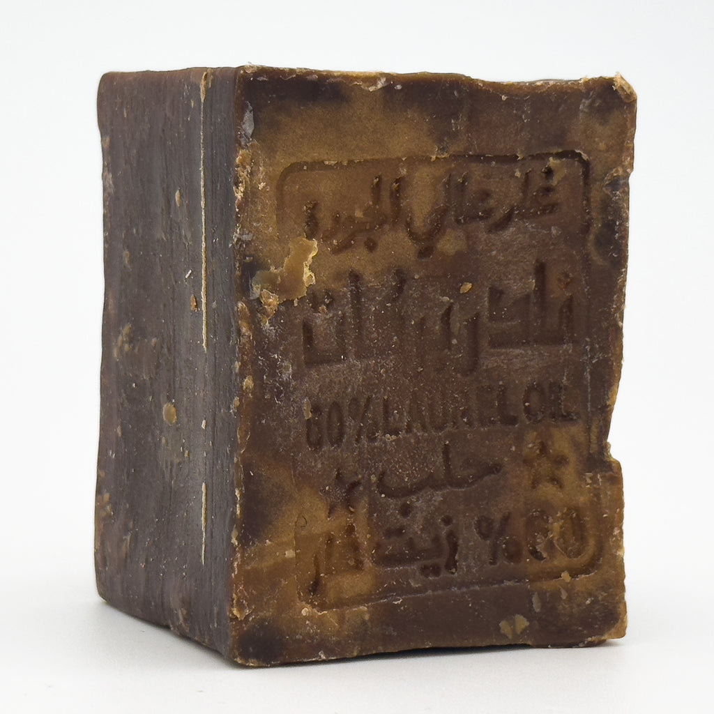 Side angle view of unwrapped Avlia Aleppo soap bar highlighting the traditional block shape