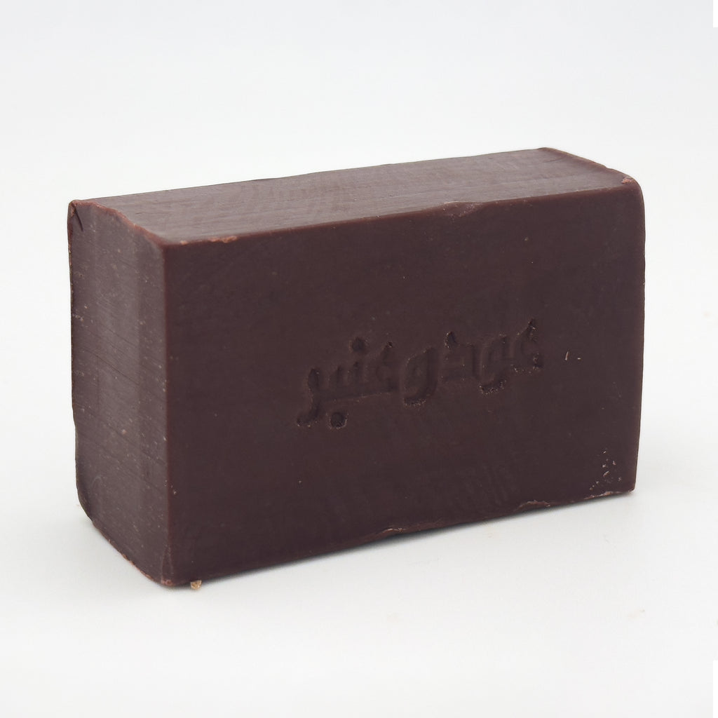 Side view of Avlia natural soap bar highlighting the thickness and engraved Arabic logo