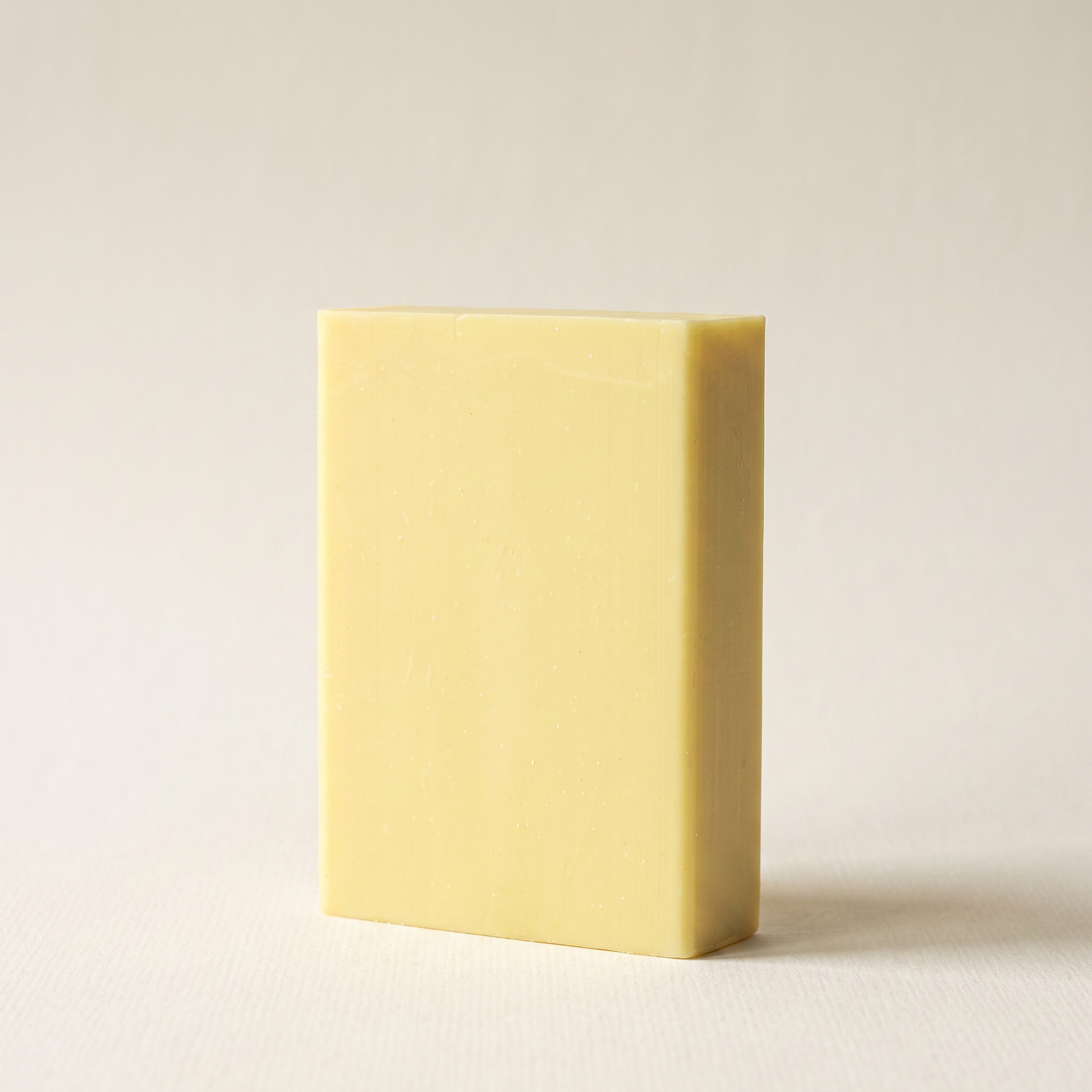 Sulfur Soap Bar standing on edge against a warm off-white backdrop, showing its hand-cut thickness