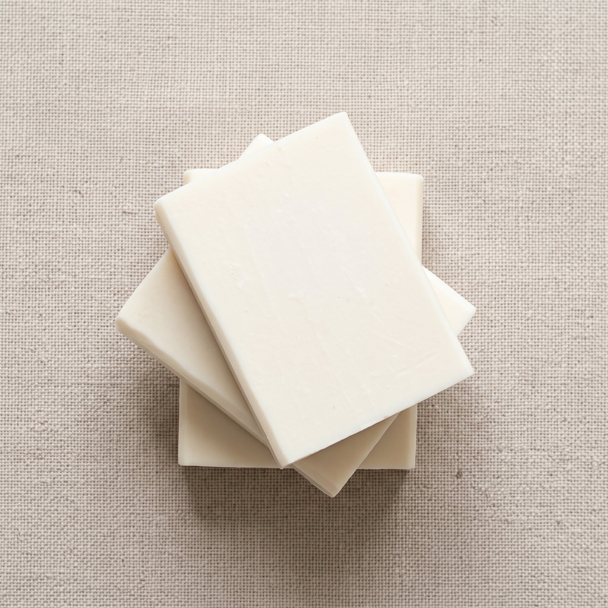 Three Jasmine Soap Bars stacked on natural linen, showing the hand-cut edges