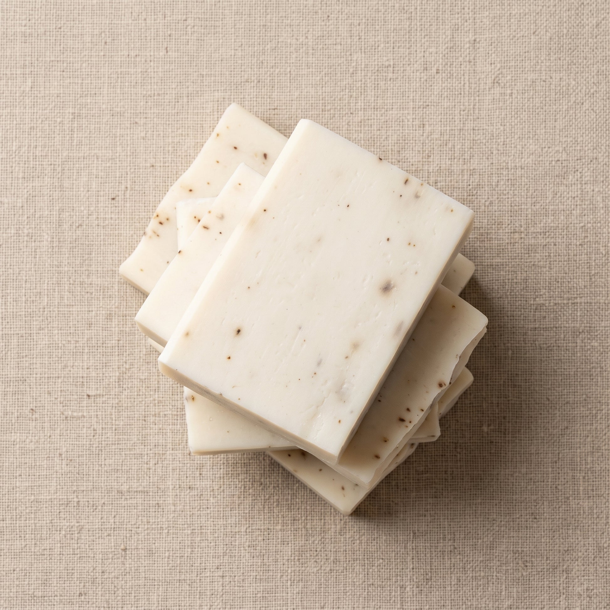 Three Lavender Soap Bars stacked on natural linen, showing the hand-cut edges