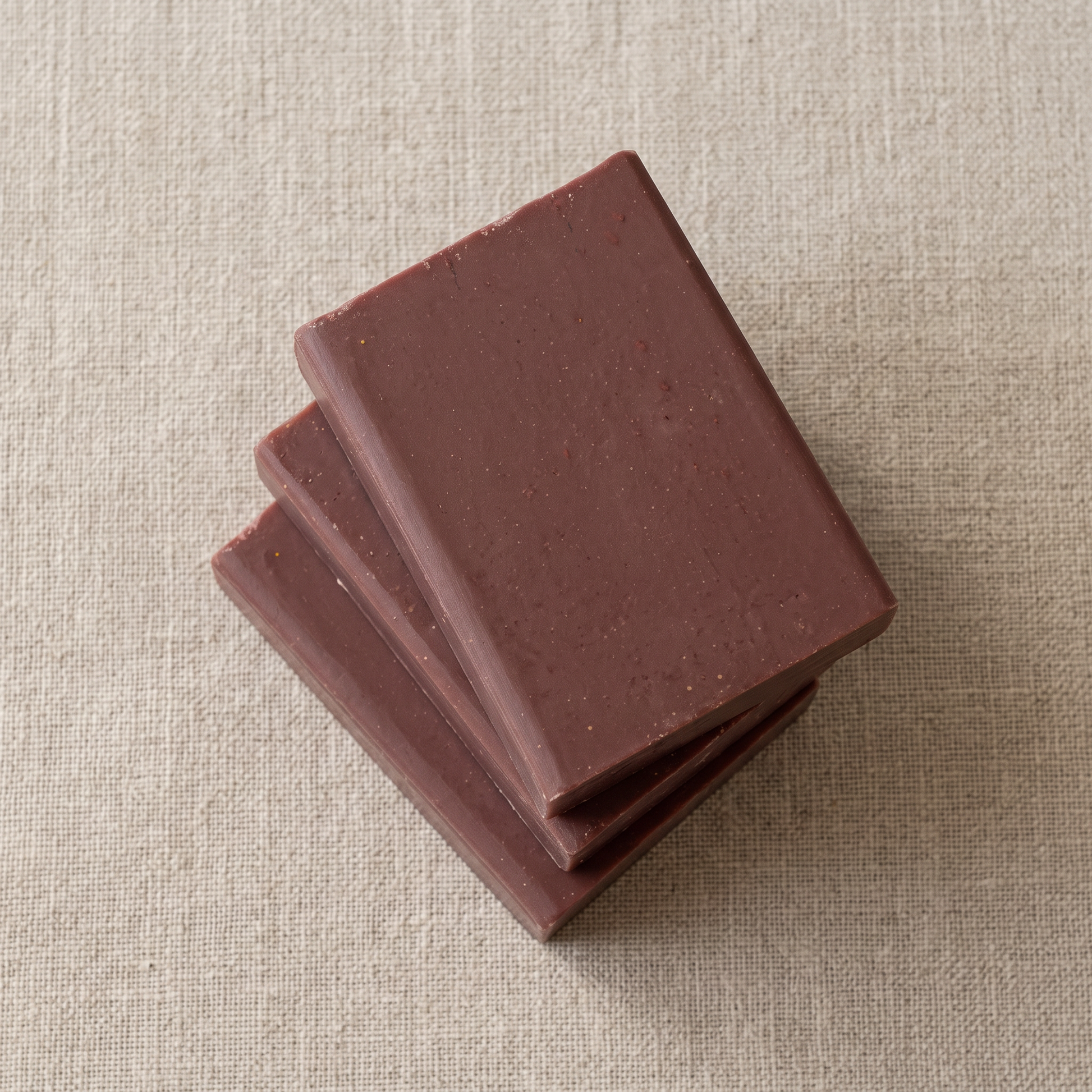 Three Pine Tar Soap Bars stacked on natural linen, showing the hand-cut edges