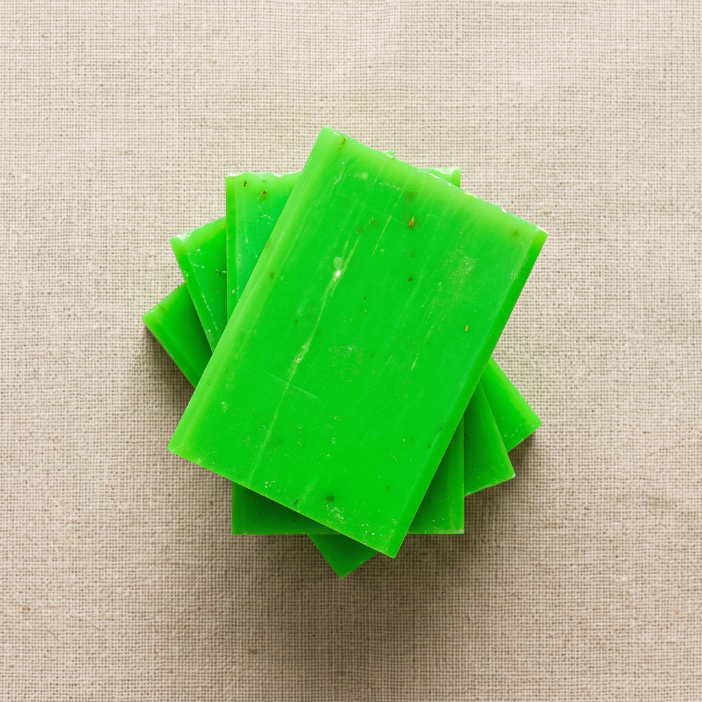Three Rosemary Soap Bars stacked on natural linen, showing the hand-cut edges
