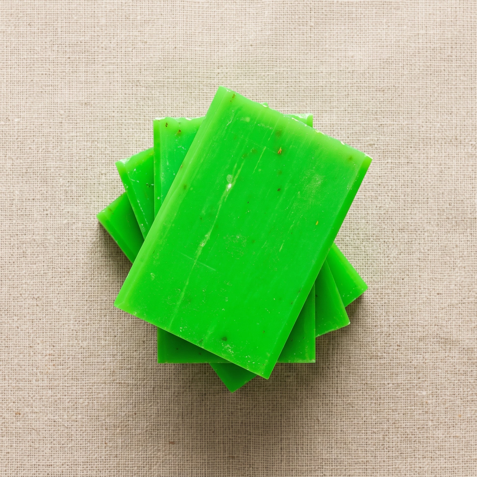 Three Rosemary Soap Bars stacked on natural linen, showing the hand-cut edges