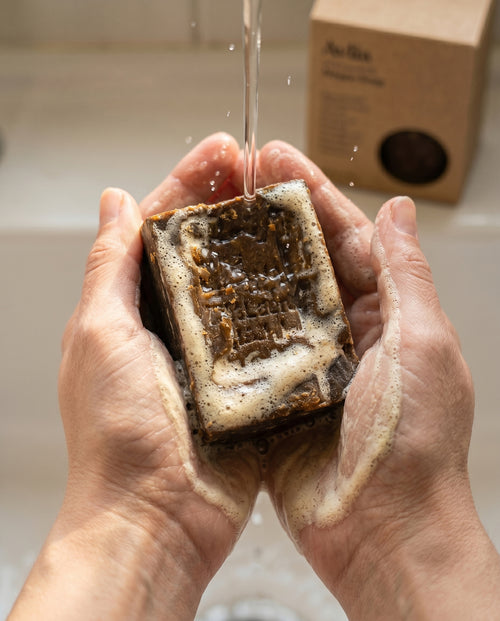 Hands lathering Avlia 75% Laurel Oil Aleppo Soap